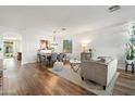 Open concept living and dining area with hardwood floors and neutral decor at 2811 E Riviera Pl, Chandler, AZ 85249