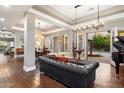 Elegant living room features hardwood floors, a grand chandelier, and views to a courtyard at 33014 N 53Rd Pl, Cave Creek, AZ 85331