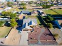 Aerial view showcasing the house, expansive yard, and surrounding landscape at 5701 N 105Th Ln, Glendale, AZ 85307