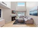 Living room with sectional sofa, fireplace, and large window at 7710 E Gainey Ranch Rd # 157, Scottsdale, AZ 85258