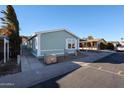 Another view of the light green manufactured home from the street at 11275 N 99Th Ave # 31, Peoria, AZ 85345