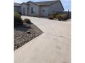 Concrete driveway leading to a single-story home at 16244 N 21 St, Phoenix, AZ 85022