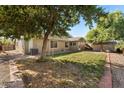 Large backyard with grassy area, mature trees, and storage shed at 1964 W Sawtooth Way, San Tan Valley, AZ 85144