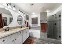 Elegant bathroom with double vanity, soaking tub, and walk-in shower at 1964 W Sawtooth Way, San Tan Valley, AZ 85144