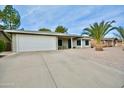 Single-story home with attached garage, driveway, and desert landscaping at 4441 E Coconino St, Phoenix, AZ 85044