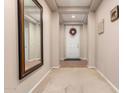 Bright entryway with tile floors, a mirror, and a wreath on the door at 45759 W Morning View Ln, Maricopa, AZ 85139
