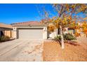 One-story house with a grey garage door and terracotta roof tiles, surrounded by desert landscaping at 586 W Viola St, Casa Grande, AZ 85122