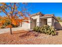 One-story house with a grey garage door and terracotta roof tiles, surrounded by desert landscaping at 586 W Viola St, Casa Grande, AZ 85122