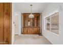 Dining area featuring a built-in hutch and light carpeting at 8140 E Cactus Dr, Mesa, AZ 85208