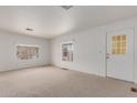 Spacious living room with neutral carpeting and large windows at 8140 E Cactus Dr, Mesa, AZ 85208