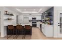 Updated kitchen featuring white cabinetry, quartz countertops, and stainless steel appliances at 14524 W Sentinel Dr, Sun City West, AZ 85375