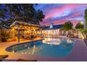Relaxing kidney shaped pool with pergola and patio furniture at 2328 N Roca St, Mesa, AZ 85213