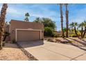 Tan stucco house with a two-car garage and desert landscaping at 25515 N Forest Rd # 1, Rio Verde, AZ 85263