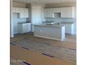 Modern kitchen featuring white cabinets and an island at 3449 S 177Th Ave, Goodyear, AZ 85338