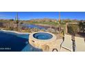 Relaxing backyard with a pool, spa, and golf course views at 41120 N Congressional Dr, Anthem, AZ 85086