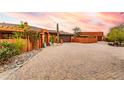 Front view of a beautiful Southwestern style home with a large courtyard at 5445 E New River E Rd, Cave Creek, AZ 85331