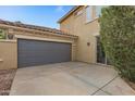 Attached two-car garage with gray doors and a side entrance at 841 E Runaway Bay Pl, Chandler, AZ 85249