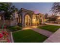 Elegant entryway with a wrought iron gate and a brick pathway at 945 W Elm St, Litchfield Park, AZ 85340
