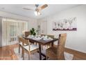 Charming dining room with wood flooring and a rustic dining table set at 10652 W Saratoga Cir, Sun City, AZ 85351