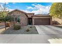 One-story home with stone and stucco exterior, two-car garage, and landscaped front yard at 17539 W Buchanan St, Goodyear, AZ 85338