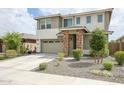 Two story home with stone accents and a two car garage at 18813 W Solano Dr, Litchfield Park, AZ 85340