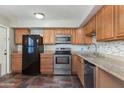 Kitchen with wood cabinets, granite counters, and stainless steel appliances at 225 N Standage -- # 10, Mesa, AZ 85201