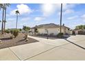 House with palm trees and a long driveway leading to the entrance at 3853 E June Cir, Mesa, AZ 85205