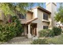 Attractive two-story home with landscaping and a walkway leading to the entrance at 4901 E Kelton Ln # 1006, Scottsdale, AZ 85254