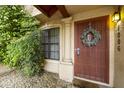 Inviting front door with a wreath, a security gate, and lush greenery at 4901 E Kelton Ln # 1006, Scottsdale, AZ 85254