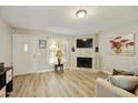 Living room with fireplace, hardwood floors and a view into the kitchen at 4901 E Kelton Ln # 1006, Scottsdale, AZ 85254