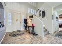 Bright and spacious entryway with staircase, wood floors, and console table at 6027 N 132Nd Dr, Litchfield Park, AZ 85340