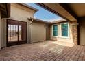 Private courtyard with brick paving and wrought-iron gate at 6523 N 135Th Dr, Glendale, AZ 85307