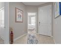 Bright entryway with tile flooring, access to bedroom, and a vase at 8522 W Georgetown Way, Florence, AZ 85132