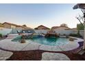 Inviting pool with waterfall feature and surrounding patio at 8601 W Chickasaw St, Tolleson, AZ 85353