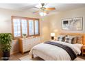 Cozy bedroom with light wood furniture and a comfortable bed at 9635 W Spanish Moss Ln, Sun City, AZ 85373