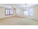 Spacious dining room featuring a chandelier and large windows at 15896 N 182Nd Ave, Surprise, AZ 85388