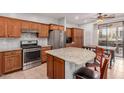 Spacious kitchen with granite countertops, wood cabinets, and stainless steel appliances at 32405 N 23Rd Ave, Phoenix, AZ 85085