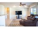 Living room with leather furniture and a large flat-screen TV at 7032 N Petersburg Ct, Florence, AZ 85132