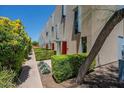 Modern townhome community with landscaped walkways and private entrances at 7047 E Earll Dr # 1002, Scottsdale, AZ 85251