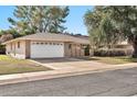 House exterior featuring a white garage door and driveway at 10205 W Royal Oak Rd, Sun City, AZ 85351