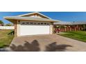 House exterior with a white garage door and a large driveway at 10728 W Cheryl Dr, Sun City, AZ 85351