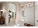 Bright entryway with view of kitchen and door to outside at 14102 W White Rock Dr, Sun City West, AZ 85375