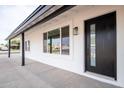 Modern front door and updated siding on a single story home at 1501 W Grovers Ave, Phoenix, AZ 85023