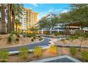 Landscaped courtyard with walking paths and modern buildings in background at 2211 E Camelback Rd # 607, Phoenix, AZ 85016