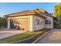 Attached garage with wood door and landscaping at 4284 W Park Ave, Chandler, AZ 85226