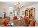 Round dining table with orange chairs and wooden shelving at 8404 S Thorne Mine Ln, Gold Canyon, AZ 85118