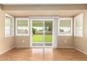 Dining room with hardwood floors, sliding glass doors, and backyard view at 18001 N 99Th Dr, Sun City, AZ 85373