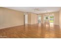 Bright living area with hardwood floors and view into adjacent dining area at 18001 N 99Th Dr, Sun City, AZ 85373