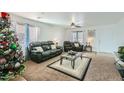 Living room with leather furniture, a coffee table, and a Christmas tree at 25763 W Satellite Ln, Buckeye, AZ 85326