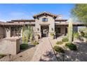 Stunning exterior of a Spanish-style home with a welcoming walkway at 7262 E Lower Wash Pass, Scottsdale, AZ 85266